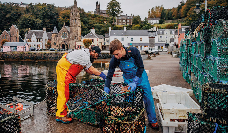 Fishermen unloading net at dock