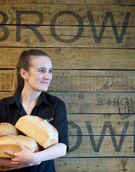 Woman holding loaves of bread