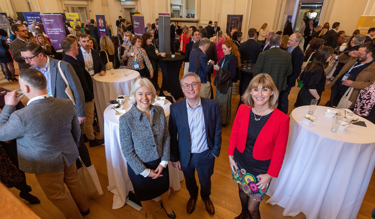 three people at conference smiling